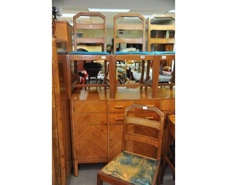 An Art Deco burr walnut dining room suite, comprising four chairs break front sideboard and dining table,