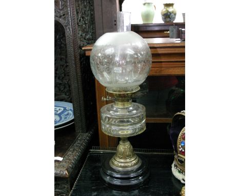 A Victorian glass oil lamp with etched shade