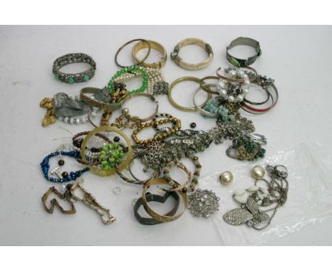 A small box of costume jewellery including a gold tone bangle