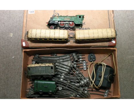 A French JEP electric train set comprising engine and tender, two carriages, goods van, track etc.