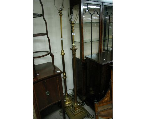 A brass Corinthian column standard lamp on a squared base.