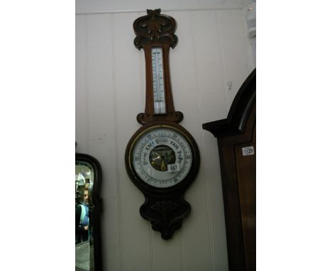 A carved oak Art Nouveau period barometer with thermometer.