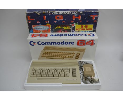 A boxed Commodore 64 console with games and accessories.