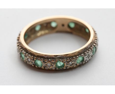 An Emrald and diamond eternity ring with alternating stones, 