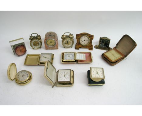 A collection of traveling alarm clocks including a boxed Oris and a Lalique style glass cased clock. 