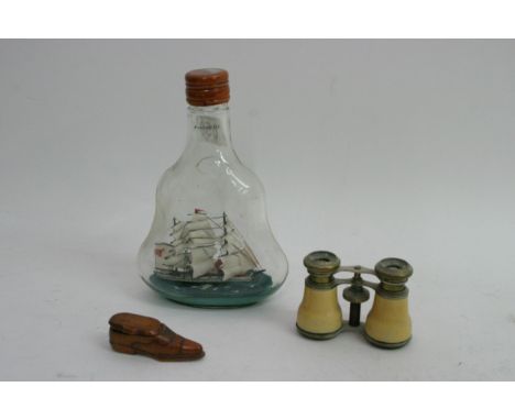 A small treen shoe snuff box, a pair of opera glasses and a ship in a bottle
