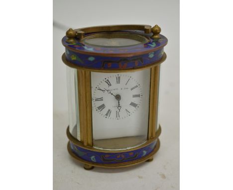 An oval Cloisonné and brass carriage clock the dial with the inscription Elliot & Son. 