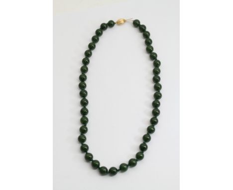 A jade bead necklace, each bead having a diameter of approximately 1cm, the necklace comprising of 41 beads, some having mino