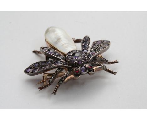 An Edwardian gold brooch in the form of an insect set with diamond chips. amethyst and mother of pearl.