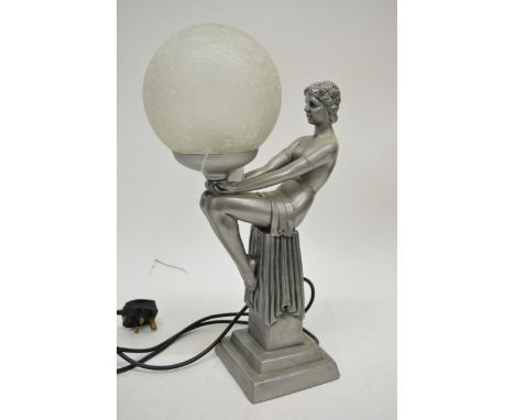 A metal Art Deco style lamp formed as semi-clad woman