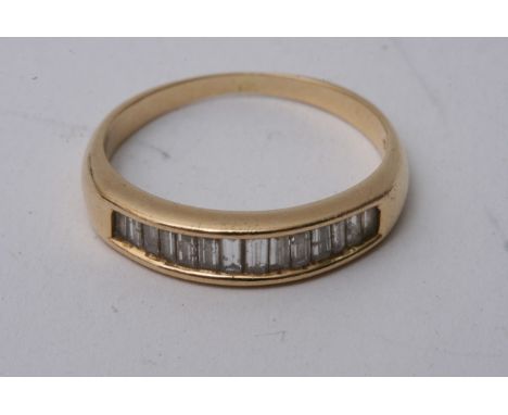 An 18ct gold ring set with baguette cut diamonds, approx 3.6g and size Q.