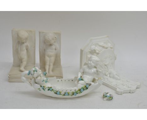 A Victorian white glazed wall shelf relief decorated with a Classical maiden, a pair of cherub bookends and a similar planter