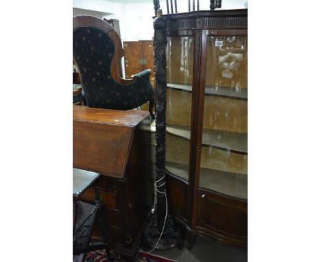 A tall carved wood oriental standard lamp