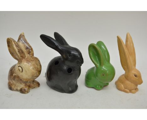 A collection of eight ceramic figures of rabbits.
