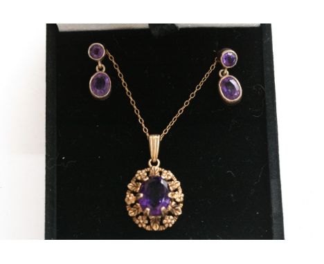 A9ct gold and Amethyst Jewellery set the pendent with a an oval central stone set in yellow gold with conforming drop earring