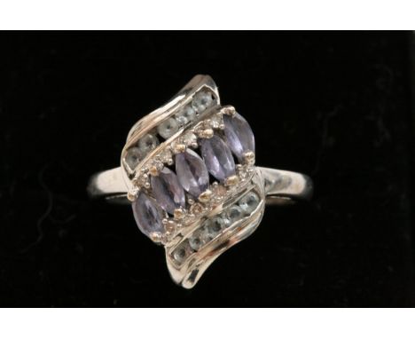 A 9ct white gold modern design ring set with alternating rows of white and coloured sapphires. 