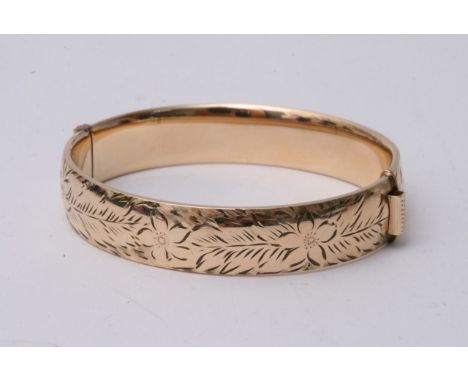 A 9ct gold bangle with metal core