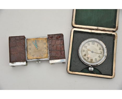Two Art Deco travelling clocks for restoration; one by Brevet Demande having crocodile skin slide opening case