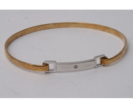 A 9ct 2 colour gold bangle set with diamond