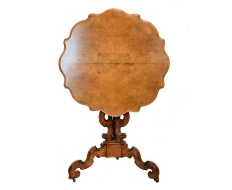 Mid 19th Century walnut snap top occasional table, the quarter-veneered wavy edge top raised on a pedestal of three scrolls a