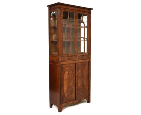 Early 20th Century mahogany cabinet, of inverted breakfront design, the upper stage with arch tracery glazed doors between re