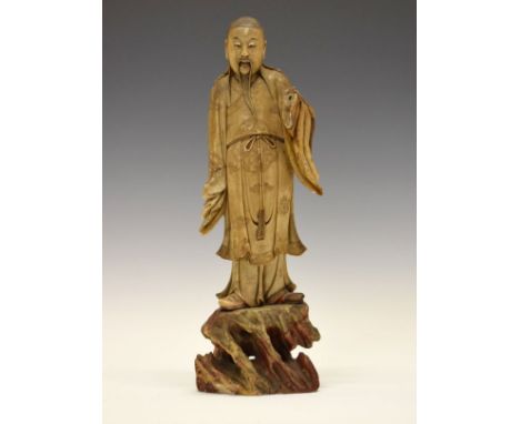 Chinese carved soapstone figure of a standing Luohan, probably 18th Century, having engraved decoration and standing on a nat