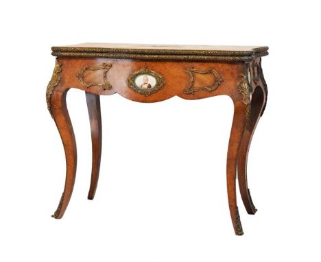 19th Century French burr walnut, tulipwood and porcelain mounted fold-over card table, the quartered serpentine top with tuli