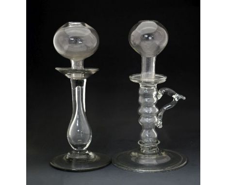 Late 18th/early 19th Century glass lace makers lamp having a loop handle, bobbin stem and standing on a circular folded foot,