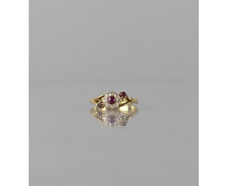 An 18ct Gold, Diamond and Ruby Floral Cluster Ring, Centre Round Cut Ruby Measuring Approx 3mm Diameter and Surrounded by Eig