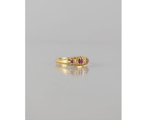 An 18ct Gold, Ruby and Diamond Seven Stone Boat Ring, Central Mixed Cut Ruby Measuring 3.5mm by 2mm Flanked by Two Sets of Sm