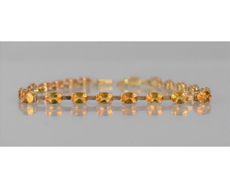 A 9ct Gold and Citrine Tennis Bracelet Comprising 20 Oval Cut Stones, Each Approx 6mm by 4mm, Mounted on Four Claws with Reed