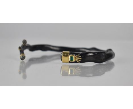 A Black Coral Bangle/Cuff, Collared in Yellow Metal and Having Mounted Emerald Cut Green Stone Mount Measuring 3mm by 2.5mm, 