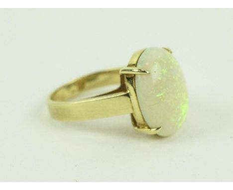 A 14CT YELLOW GOLD OPAL SET DRESS RING, the large cabouchon opal of approximately 3 carats, claw set and open backed, ring si