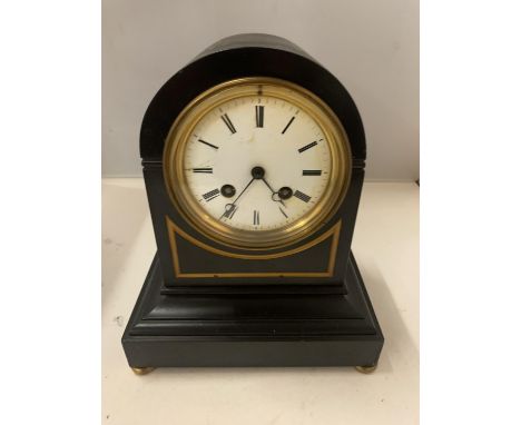 AN EARLY 19TH CENTURY FRENCH SLATE MANTLE CLOCK WITH ENAMEL FACE AND ROMAN NUMERALS 