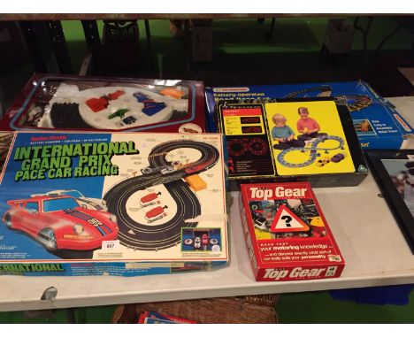 A QUANTITY OF TOYS TO INCLUDE, A BOXED RADIO SHACK SCALEXTRIC STYLE RACING TRACK, A POWER TRACK RACING TRACK, TWO MORE RACING