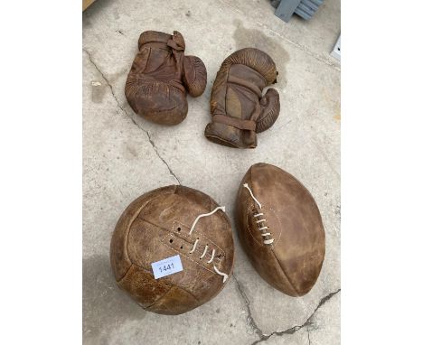 AN ASSORTMENT OF VINTAGE SPORTS EQUIPMENT TO INCLUDE A FOOTBALL AND BOXING GLOVES ETC 