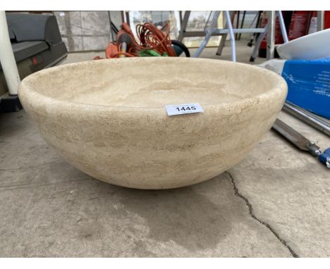 A CREAM WASH BASIN FORMED FROM A SOLID PIECE OF MARBLE 
