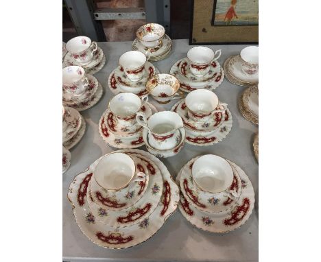 A QUANTITY OF RED AND WHITE FLORAL PATTERNED CHINA CUPS, SAUCERS, PLATES, CREAM JUG, SUGAR BOWL, ETC 