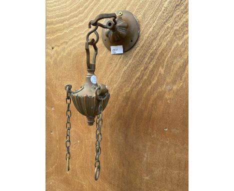 A SMALL DECORATIVE COPPER WALL HANGING BRACKET 