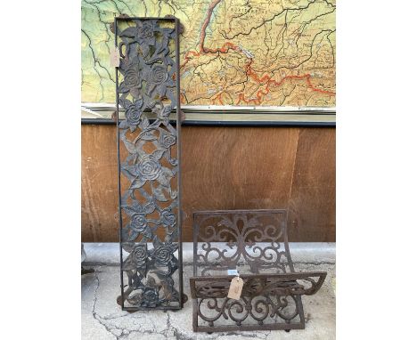 A WROUGHT IRON LOG RACK AND A CAST BENCH BACK 