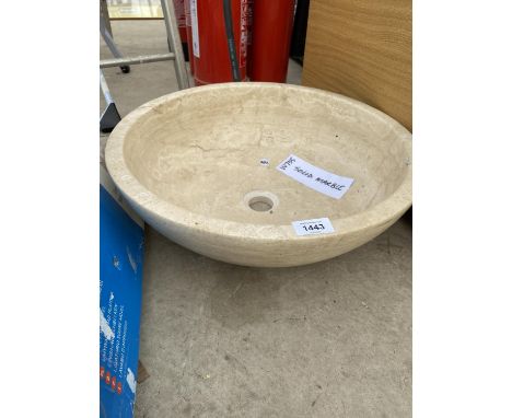 A CREAM WASH BASIN FORMED FROM A PIECE OF MARBLE 
