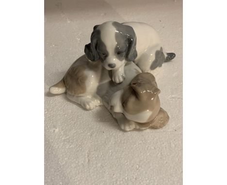 A NAO FIGURINE OF TWO PUPPIES 