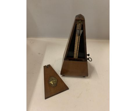 A MAHOGANY CASED METRONOME 
