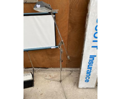 AN ADJUSTABLE WORK LIGHT ON TRIPOD BASE 