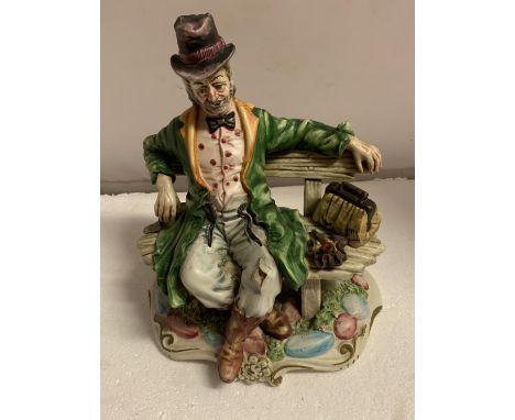 A NAO FIGURE OF A MAN ON A BENCH 