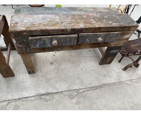A VINTAGE WOODEN WORK BENCH ENCLOSING TWO DRAWERS 