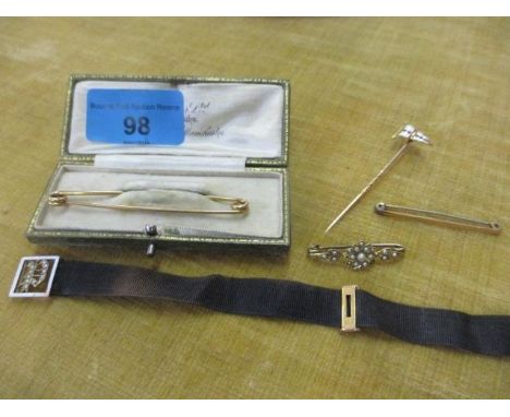 A quantity of bar brooches and pins to include an enamelled yellow metal flag pin brooch and a yellow metal and seed pearl ba