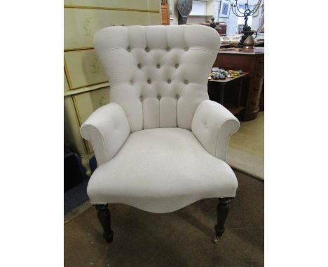 A Victorian mahogany button back upholstered armchair on turned front legs 