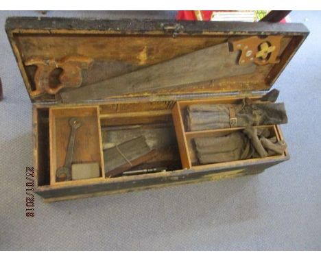 A vintage rectangular wooden tool box containing a quantity of vintage tools to include a Canadian Disston wooden handled saw