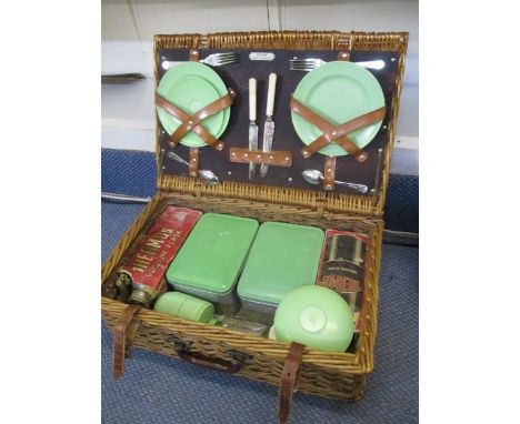 A vintage picnic basket with contents 
